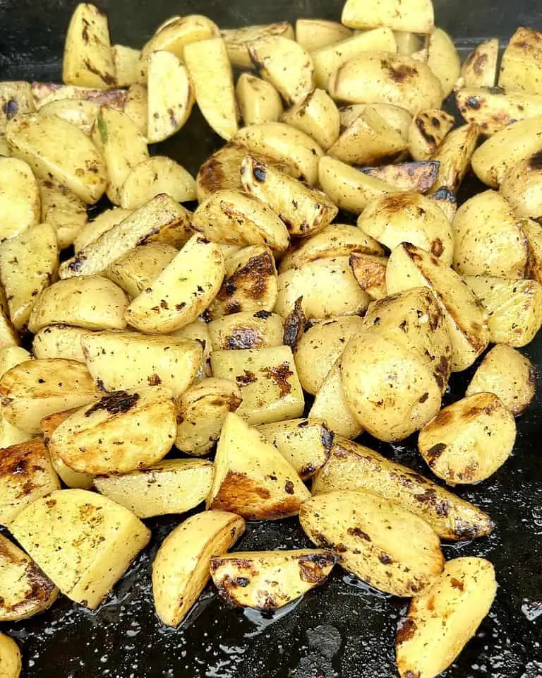 Delicious potatoes with greek style marinade being prepared on the griddle