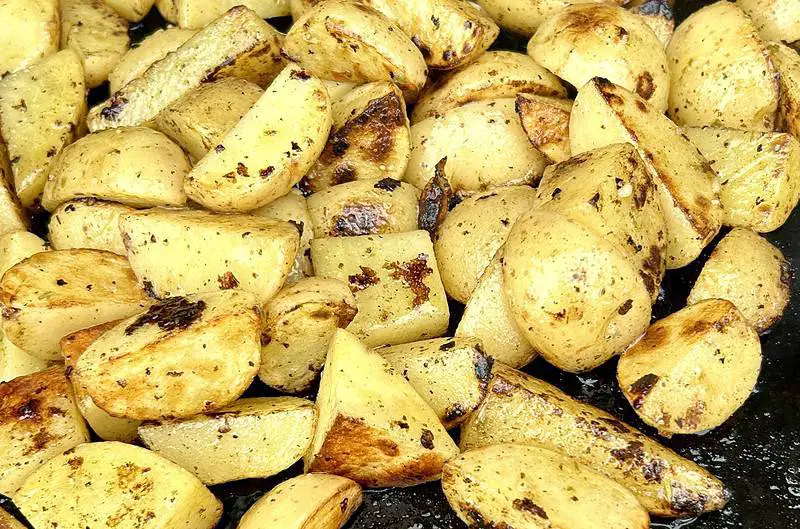 Delicious potatoes with greek style marinade being prepared on the griddle
