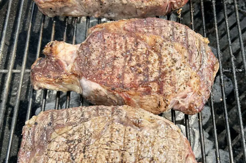 dry-aged rib eye steak on the grill almost ready to eat