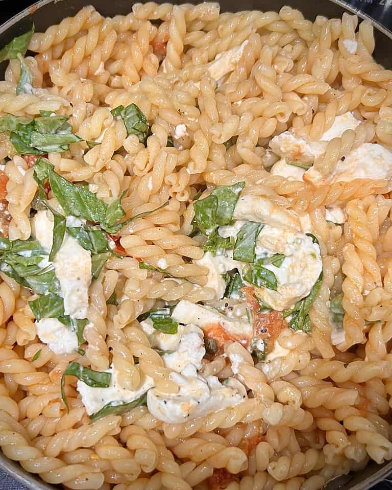 Delicious finished product of tomato and caper sauce mixed in with mozzarella and basil mixture. 