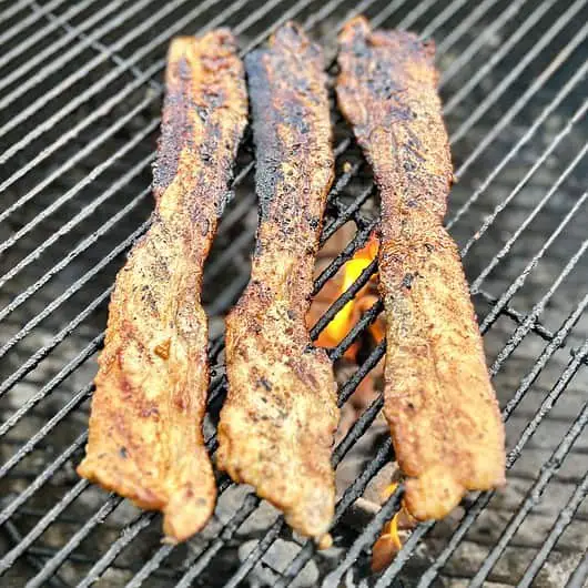 Sweet and spicy marinade Korean Pork Belly on the grill with a deliciously red tint
