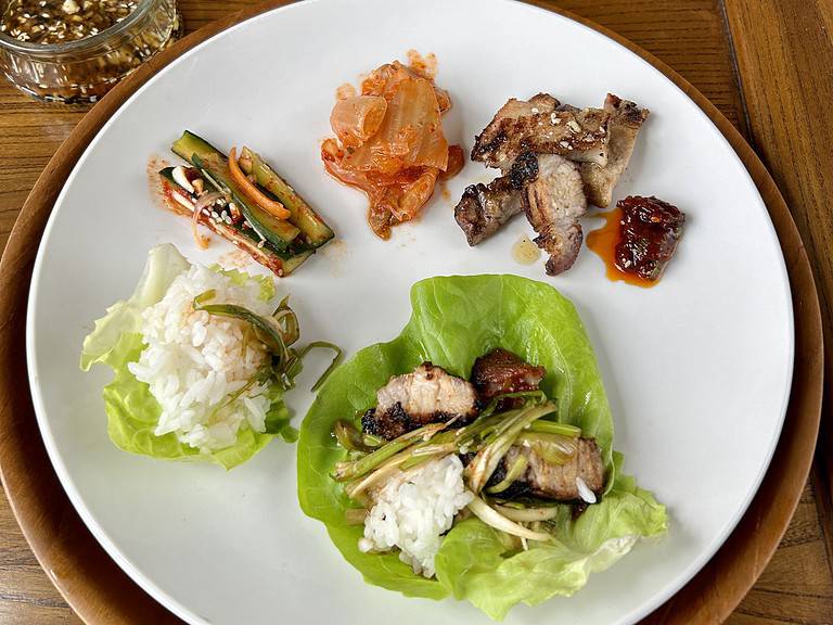 Beautifully served pork belly with banchan on the plate