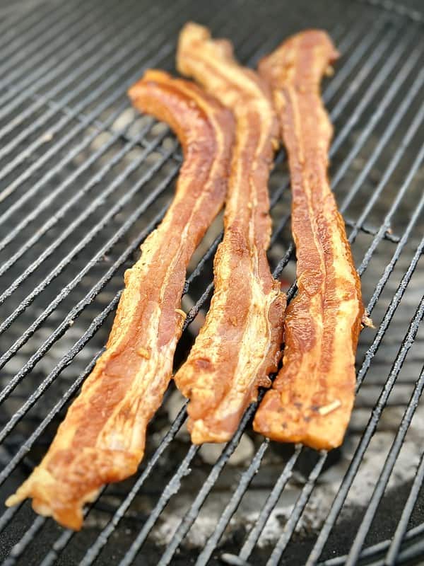 Deliciously hot and sweey marinade pork belly just placed on the grill for cooking
