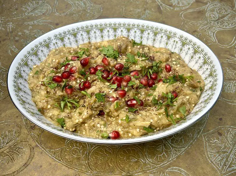 Smoky eggplant puree served with parsley, mint, and pomegranate