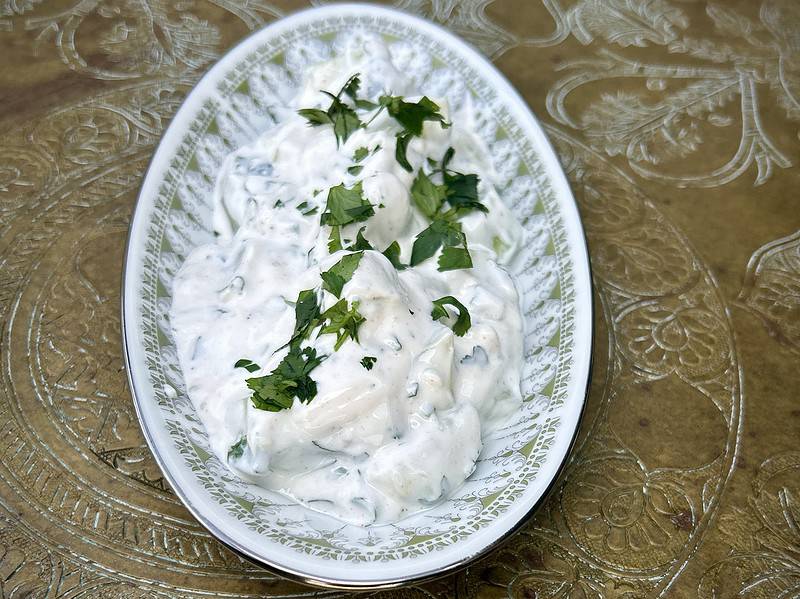 Deliciously fresh tzatziki side with Greek yogurt, cucumbers, parsley, cilantro, and garlic