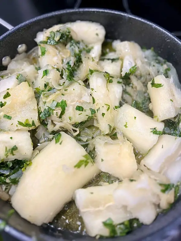 Cuban style yuca with mojo with onions, lime, and herbs is a delicious side dish for your grilled meats